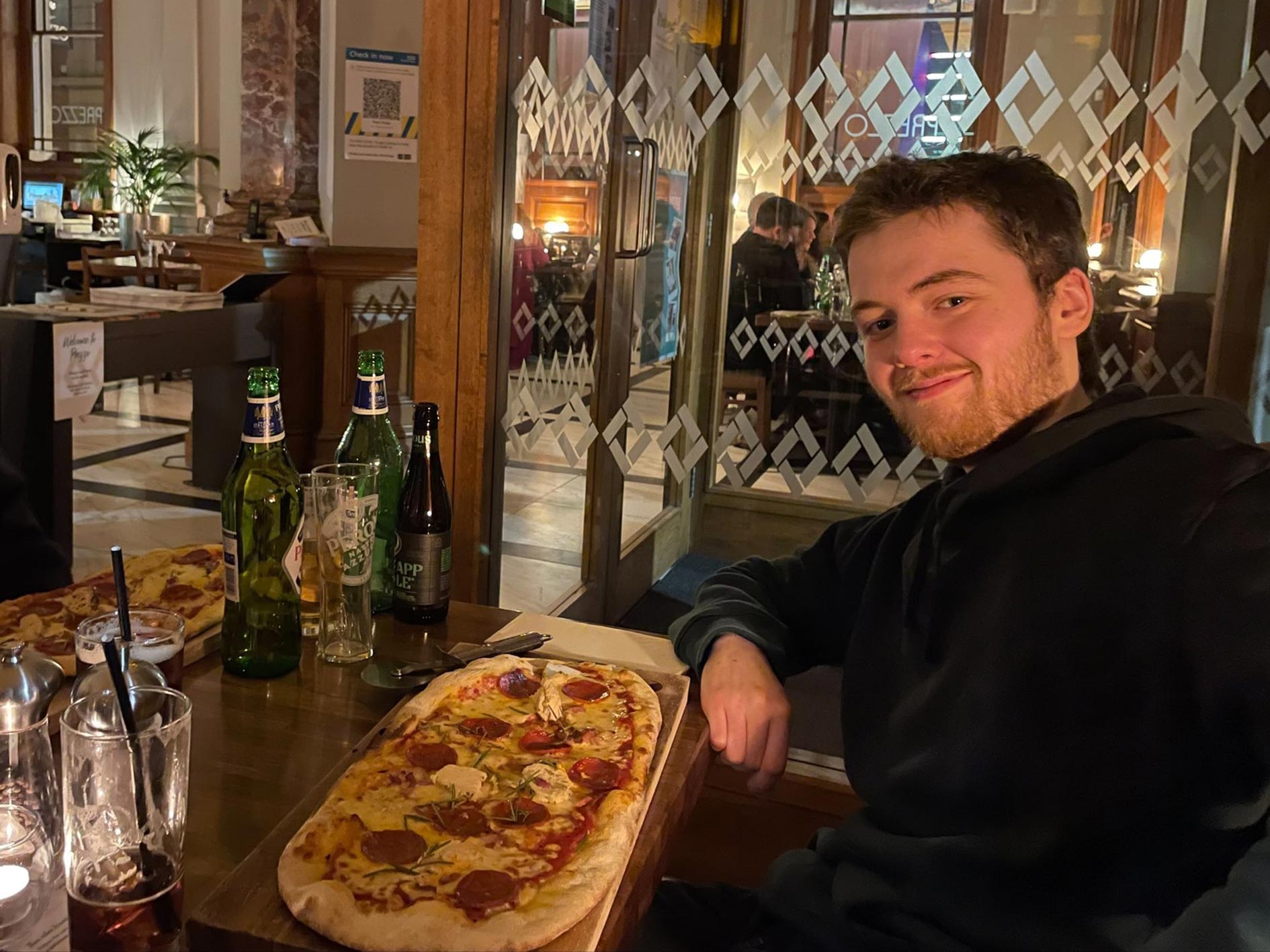 Slefie of Kyle and his pizza